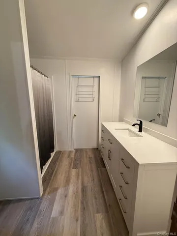 a spacious bathroom with a double vanity sink and a mirror