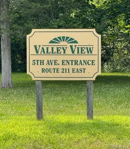 a sign broad in the middle of a park