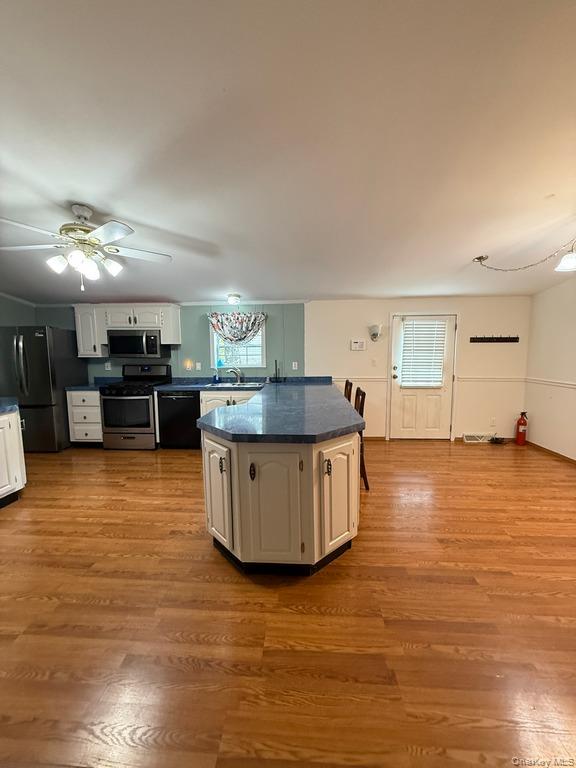 551 5th Avenue Middletown, NY 10941 - Photo 9 of 25 Kitchen featuring black appliances, dark countertops, wood finished floors, ceiling fan, and white cabinets