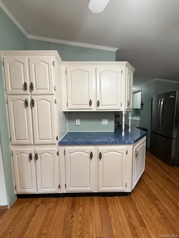 a kitchen with granite countertop white cabinets and white appliances
