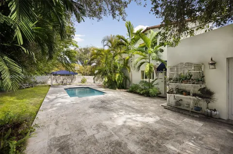 a view of yard with swimming pool and seating area