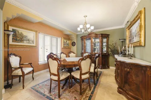a view of a dining room with furniture and chandelier