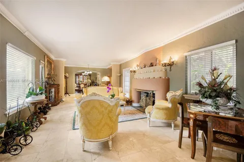 a living room with fireplace furniture and a large window