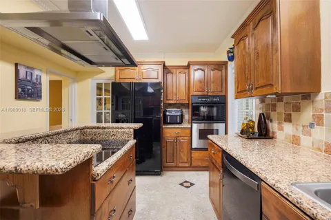 a kitchen with granite countertop stainless steel appliances and counter space