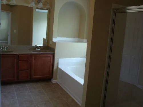 a bathroom with a bathtub and a sink