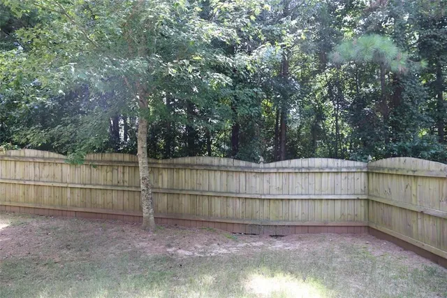 a view of a backyard with a small trees