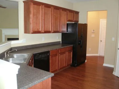 a kitchen with stainless steel appliances granite countertop a refrigerator and a sink