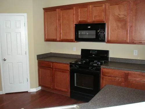 a kitchen with granite countertop stainless steel appliances and cabinets