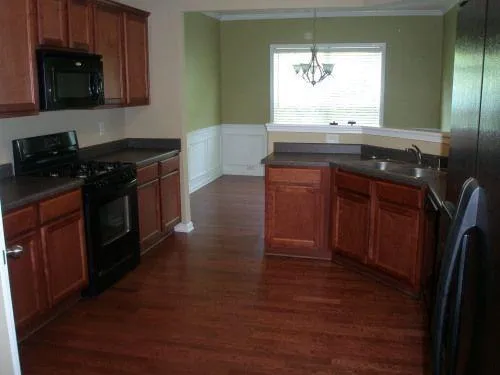 a kitchen with granite countertop a stove and a sink
