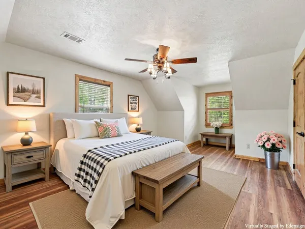 a spacious bedroom with a bed and a chandelier