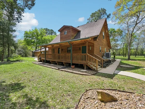 a view of a house with yard and sitting area