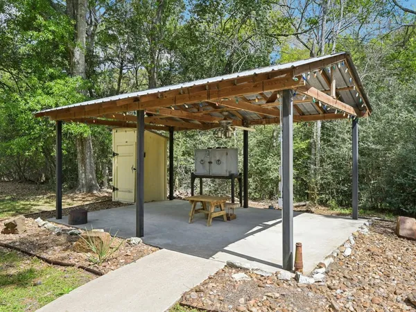 a view of a patio with a table chairs and a backyard