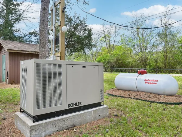a white house that has a tree in front of it