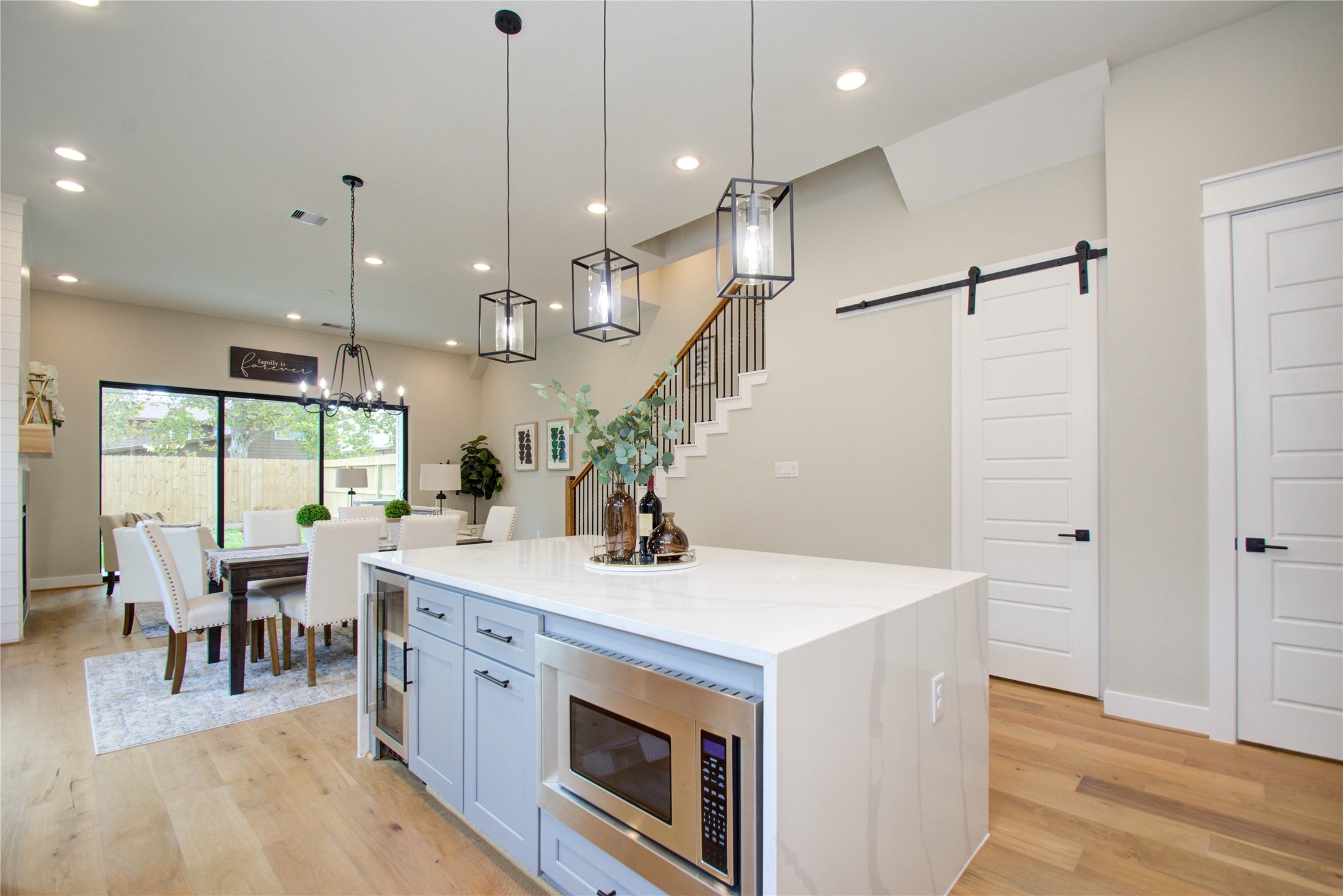 110 East 28th Street Houston, TX 77008 - Photo 10 of 43 a view of kitchen with stainless steel appliances wooden floor dining table and chairs