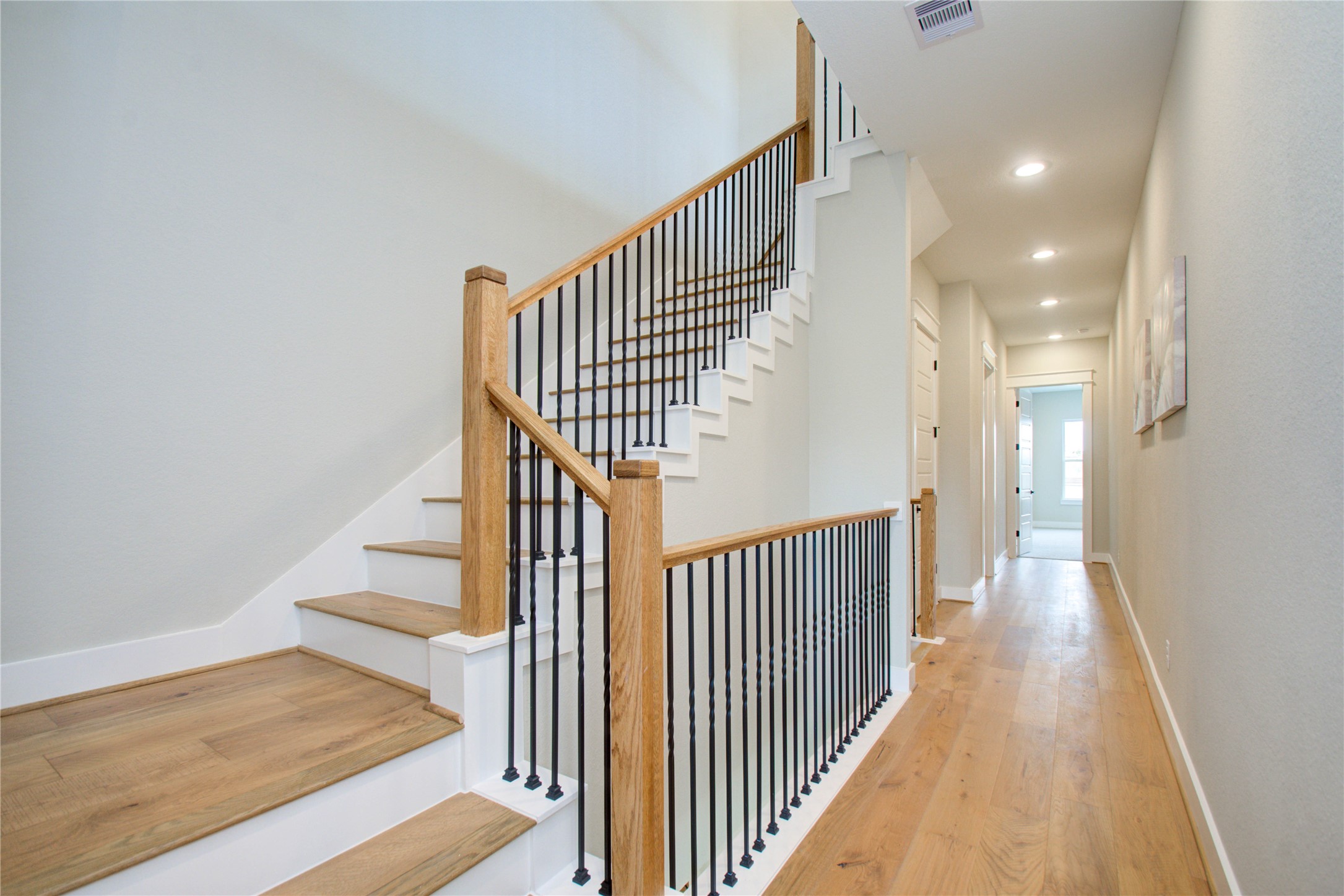 110 East 28th Street Houston, TX 77008 - Photo 13 of 43 a view of a hallway with wooden floor and staircase