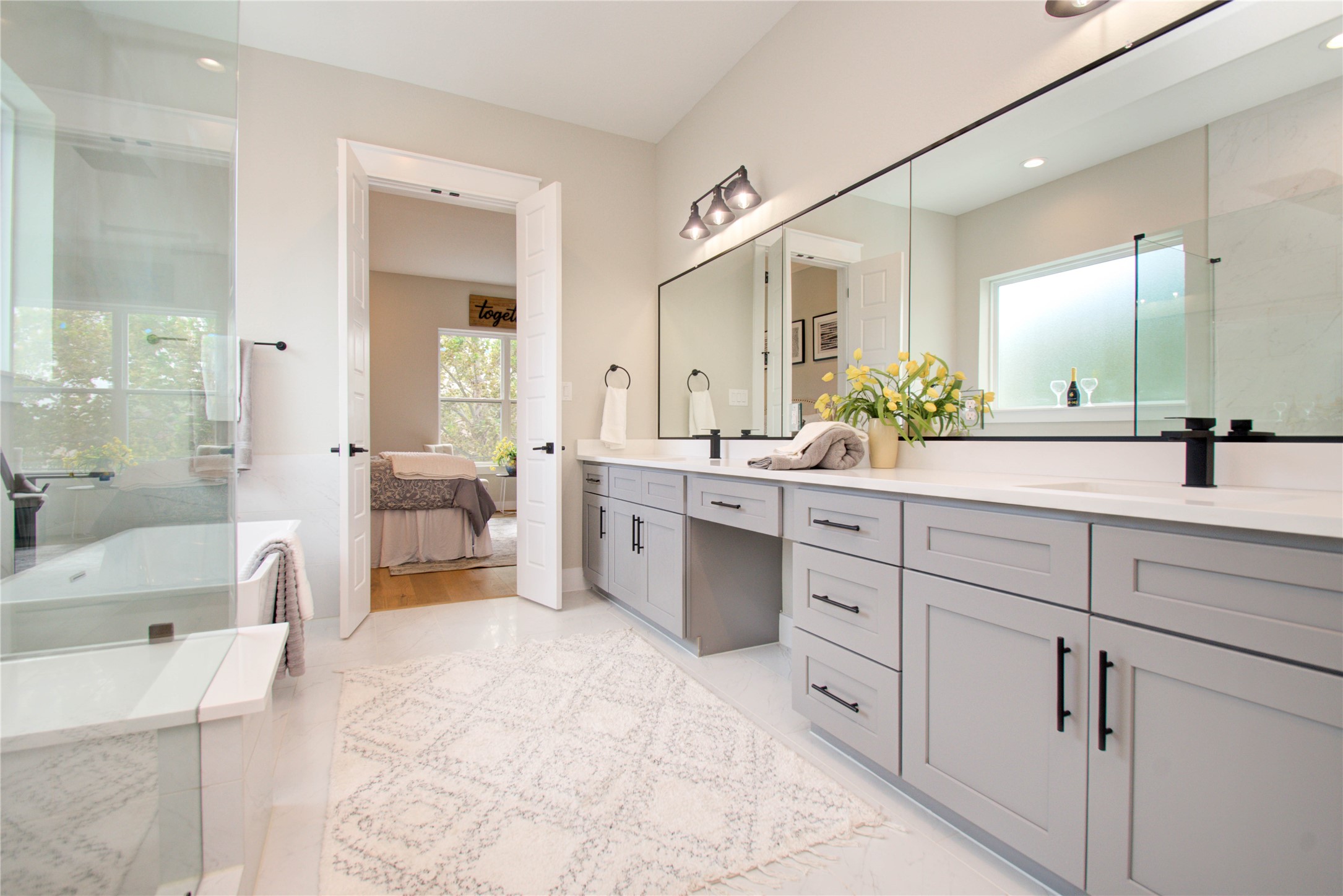110 East 28th Street Houston, TX 77008 - Photo 16 of 43 a spacious en suite bathroom with a double vanity sink a large mirror and a bathtub