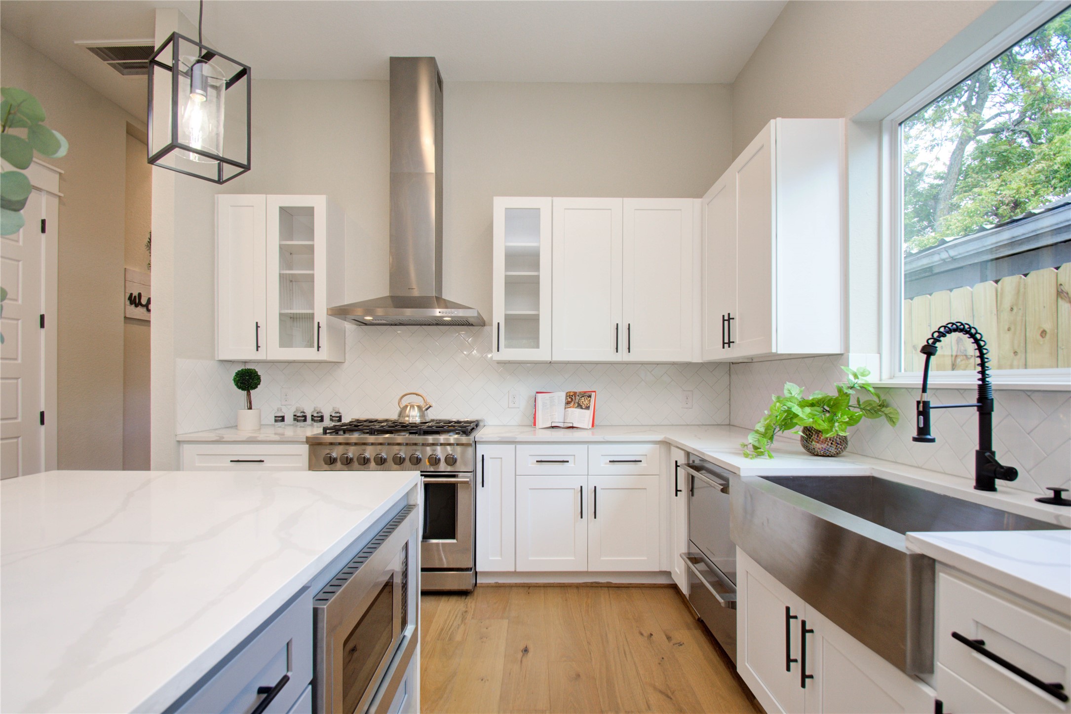 110 East 28th Street Houston, TX 77008 - Photo 19 of 43 a kitchen with stainless steel appliances a sink a stove a refrigerator cabinets and a window