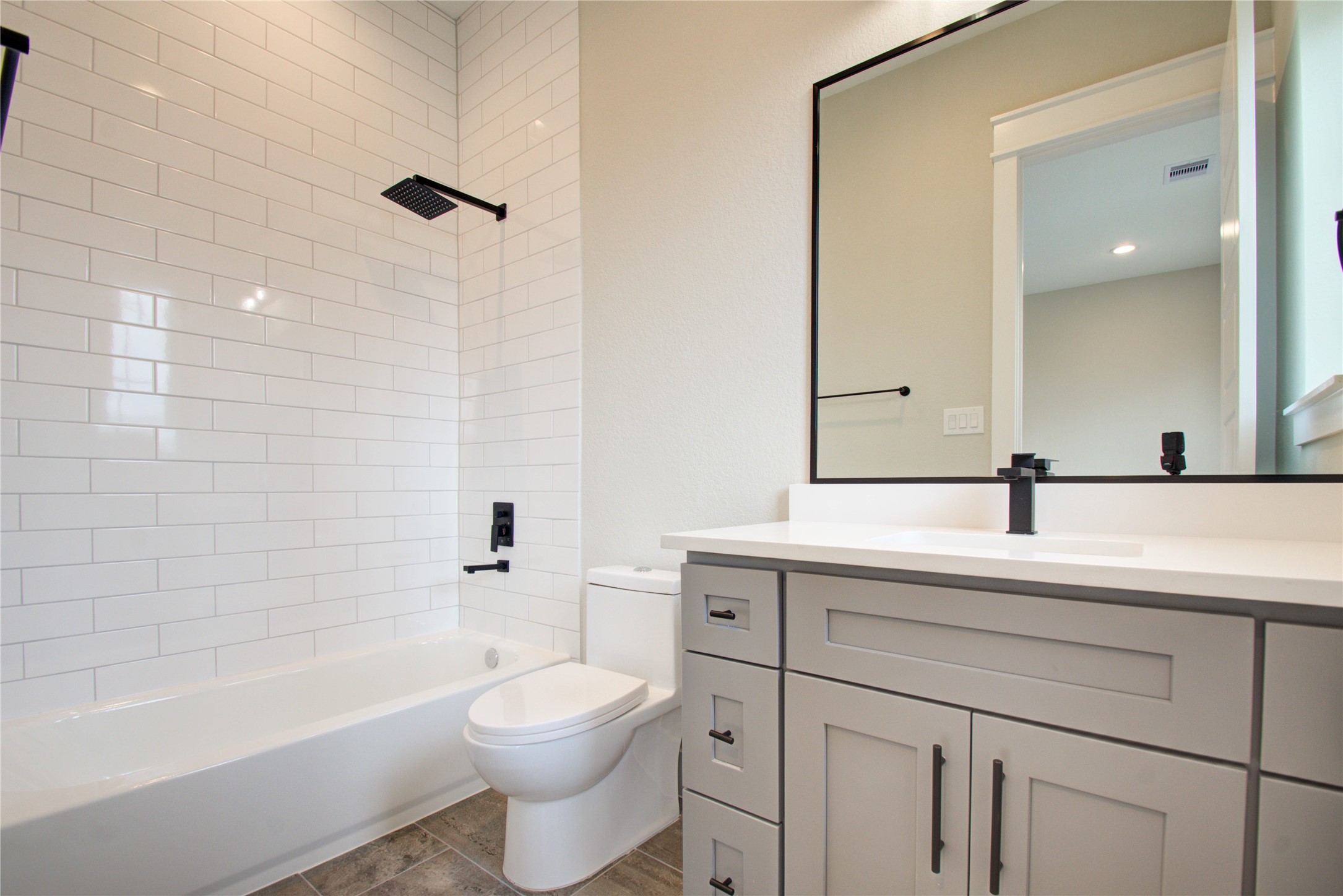 110 East 28th Street Houston, TX 77008 - Photo 34 of 43 a bathroom with a toilet a sink a mirror a bathtub and vanity
