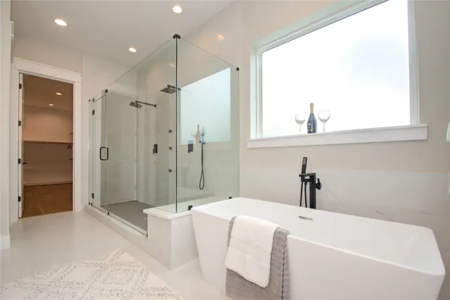 a bathroom with a tub sink and shower