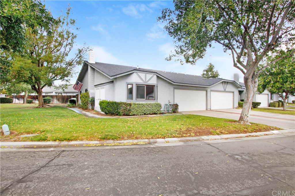 9019 Chaucer Circle Riverside, CA 92503 - Photo 1 of 1 a view of a house with a big yard and large trees