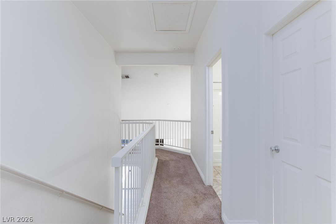 2246 Ramsgate Drive Henderson, NV 89074 - Photo 12 of 36 A well-lit second-story landing offers carpeted comfort and a pristine white railing overlooking the lower level.