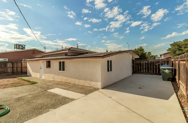 a view of a house with a backyard and a garage