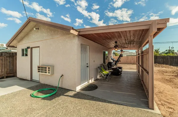 a table and chairs in front of a house