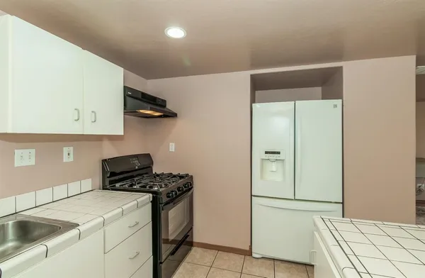 a kitchen with a refrigerator and a sink