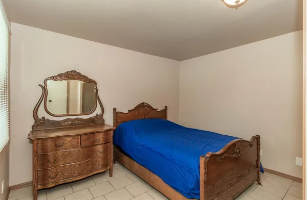 a room with a bed and cabinets