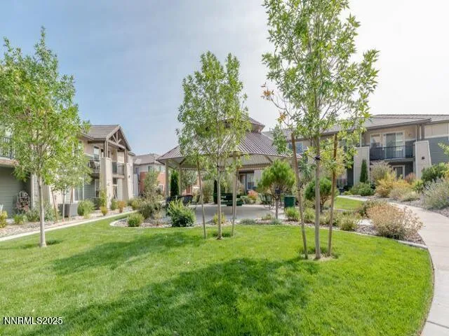 a view of a house with backyard sitting area and garden
