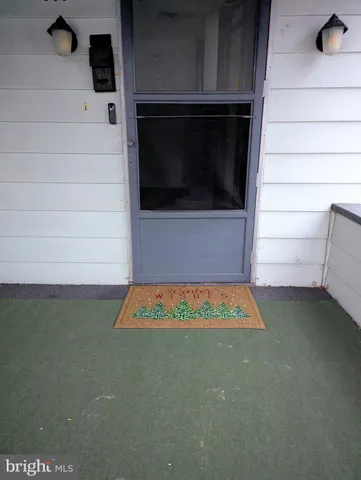 a view of staircase with white walls and a window