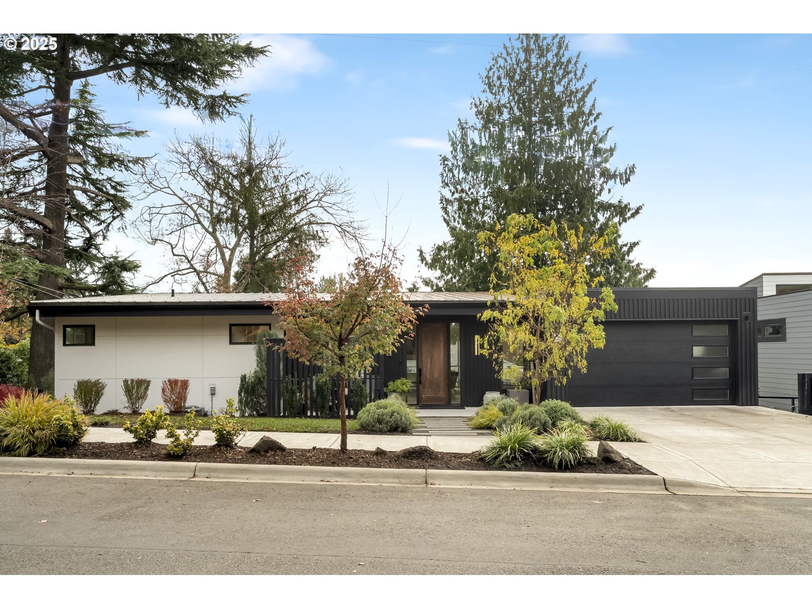 11504 Northwest Damascus Street Portland, OR 97229 - Photo 2 of 48 a front view of a house with a yard and garage