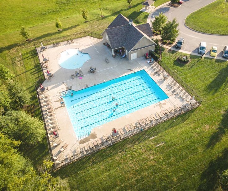 a view of a swimming pool with a yard