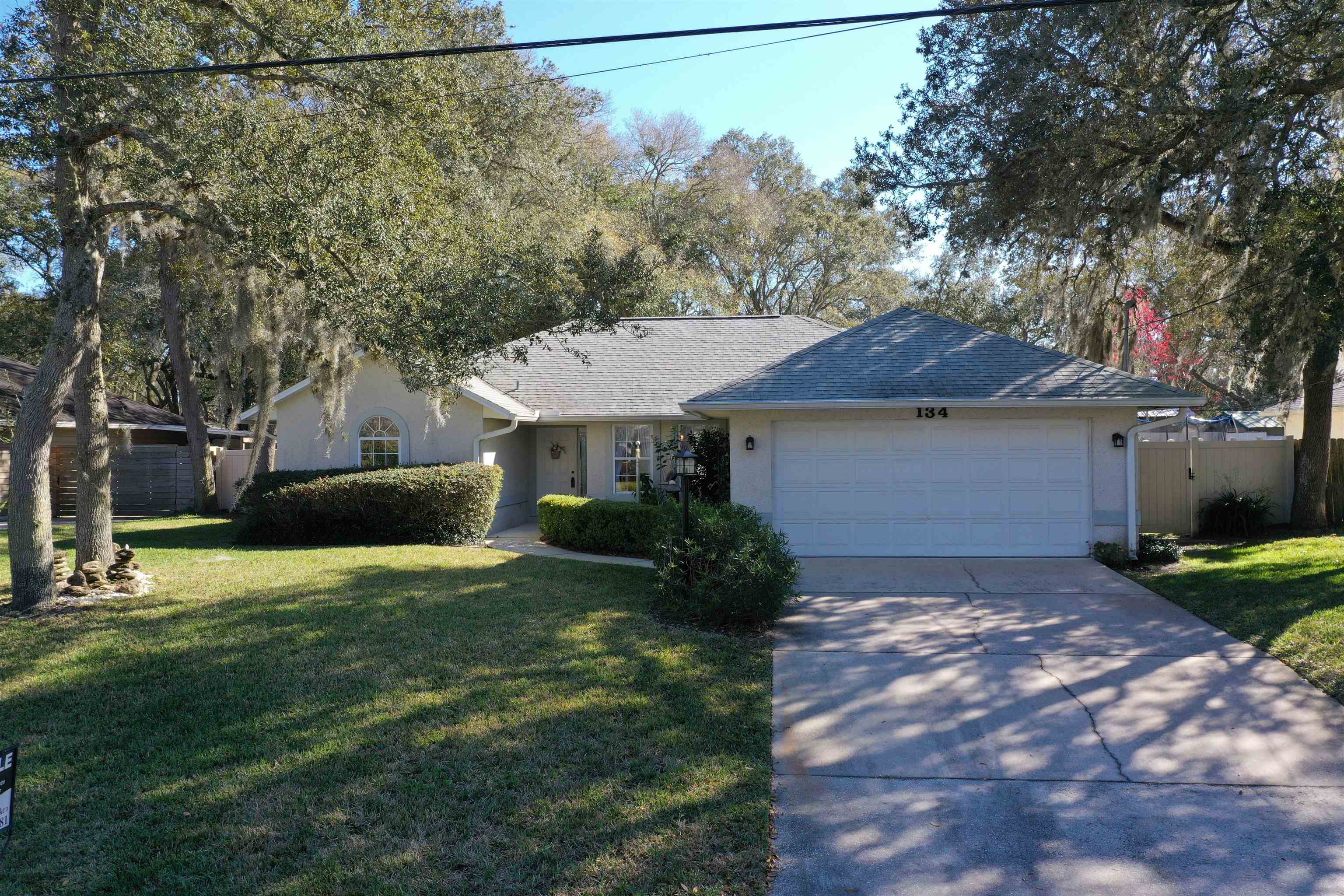 134 Pelican Road St. Augustine, FL 32086 - Photo 3 of 43 a front view of a house with a yard and garage