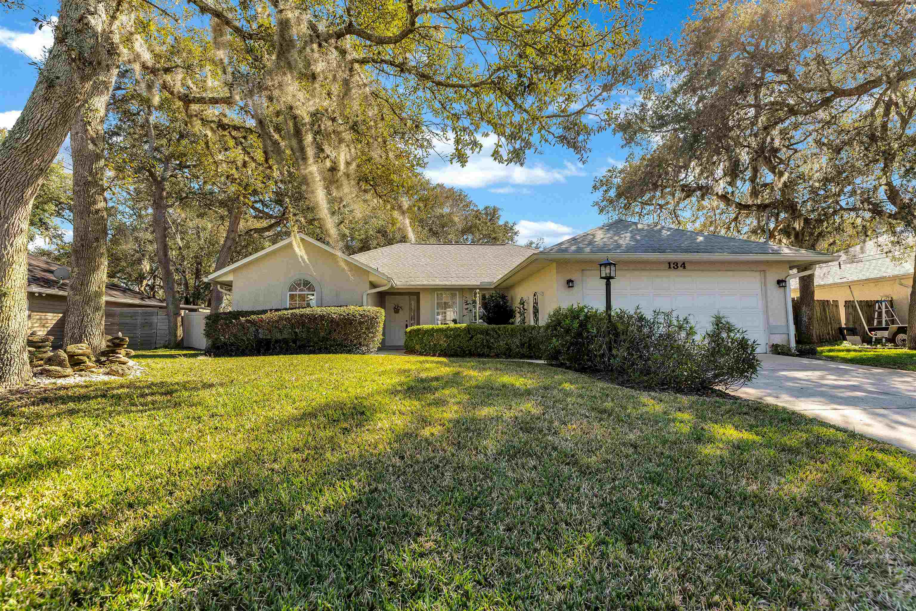134 Pelican Road St. Augustine, FL 32086 - Photo 8 of 43 a front view of a house with a garden and yard