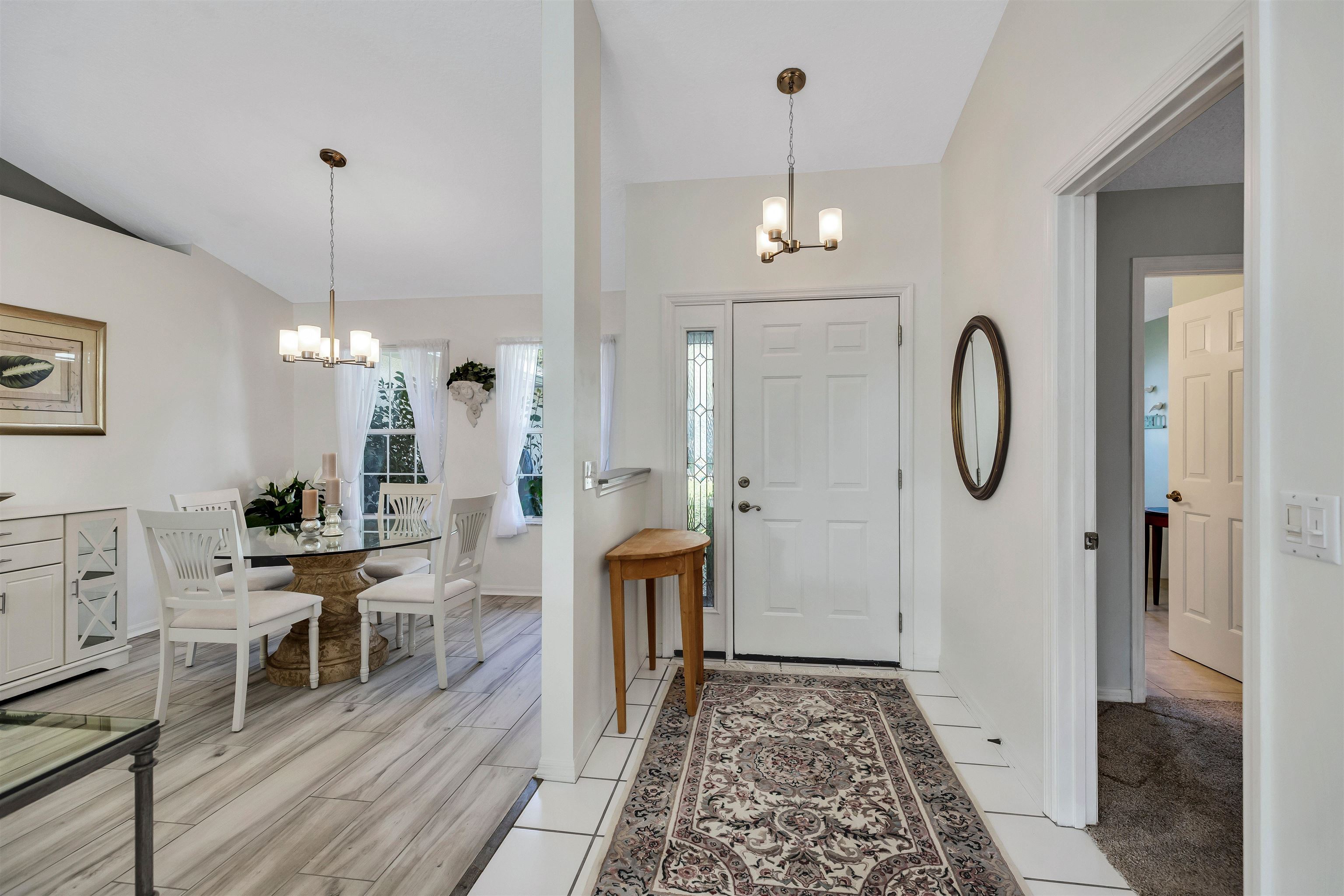 134 Pelican Road St. Augustine, FL 32086 - Photo 10 of 43 a view of a hallway with wooden floor windows and a chandelier
