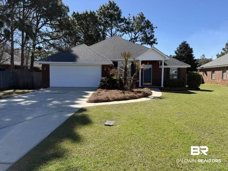 10428 South Side Loop Fairhope, AL 36532 - Photo 1 of 28 Single story home featuring a shingled roof, concrete driveway, an attached garage, fence, and a front lawn