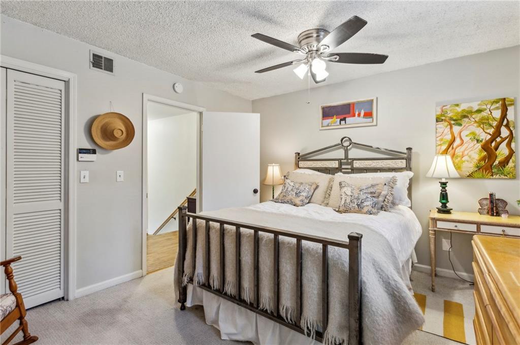 162 Lablanc Way Northwest Atlanta, GA 30327 - Photo 13 of 22 a bedroom with a bed and a chandelier