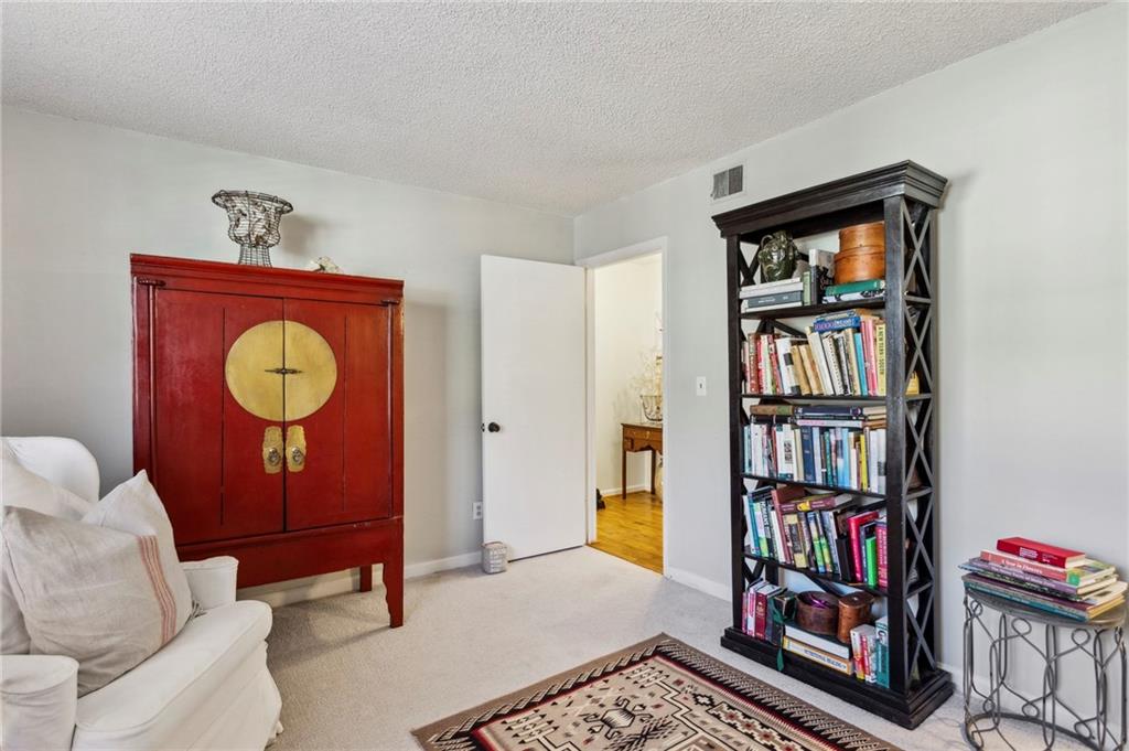 162 Lablanc Way Northwest Atlanta, GA 30327 - Photo 18 of 22 a living room with furniture a book shelf and a book shelf