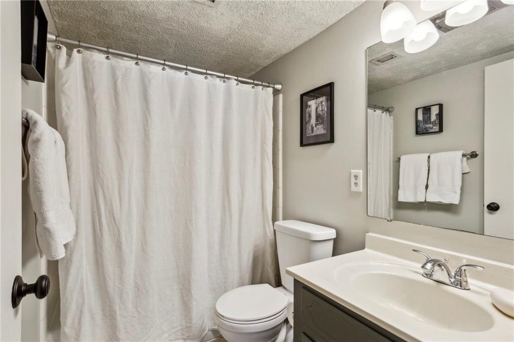 162 Lablanc Way Northwest Atlanta, GA 30327 - Photo 19 of 22 a bathroom with a sink a toilet and shower curtain