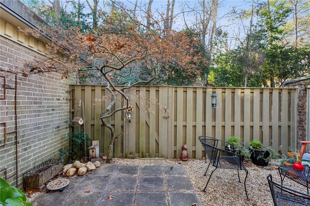 162 Lablanc Way Northwest Atlanta, GA 30327 - Photo 20 of 22 a backyard of a house with chairs and a tree