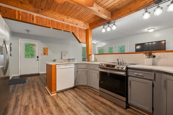 a kitchen that has a sink and a stove in it