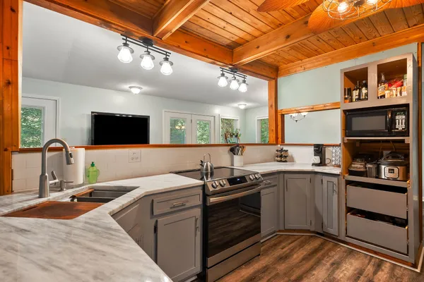 a bedroom with a bed and a flat tv screen on dresser