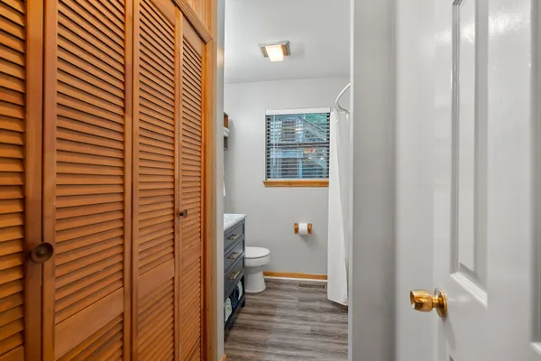 a view of a bathroom with a shower and a room