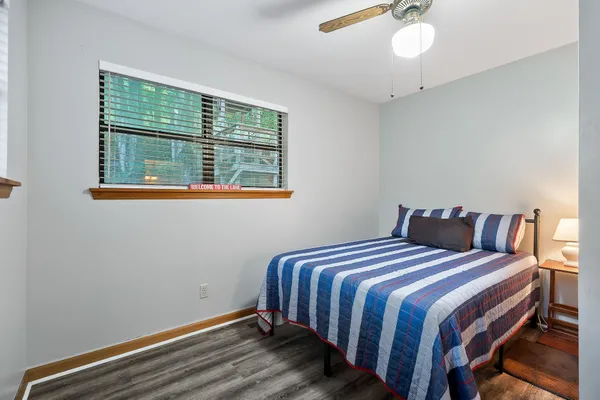 a view of a hallway with wooden floor and entryway