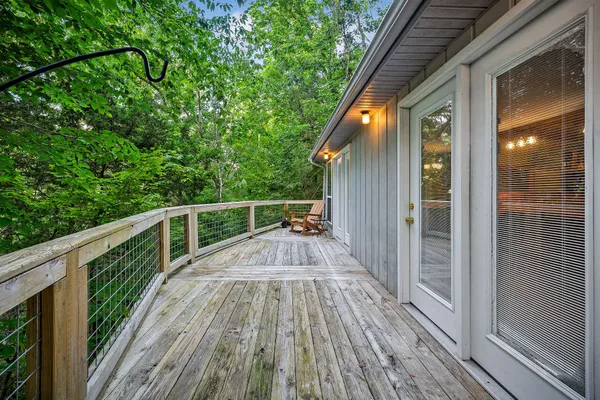a view of balcony with chairs and wooden fence