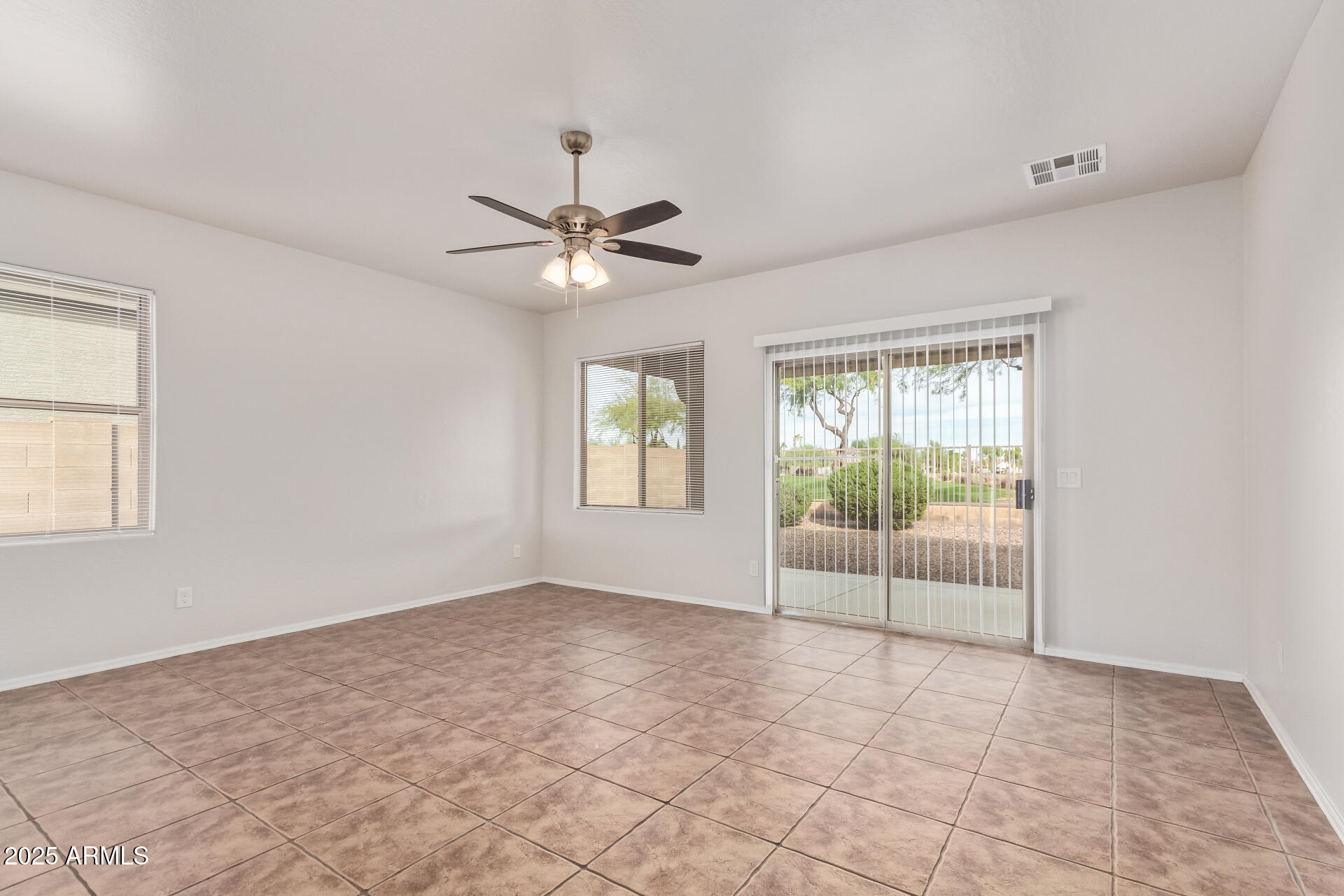 21382 East Via Del Rancho Queen Creek, AZ 85142 - Photo 2 of 29 an empty room with windows and fan