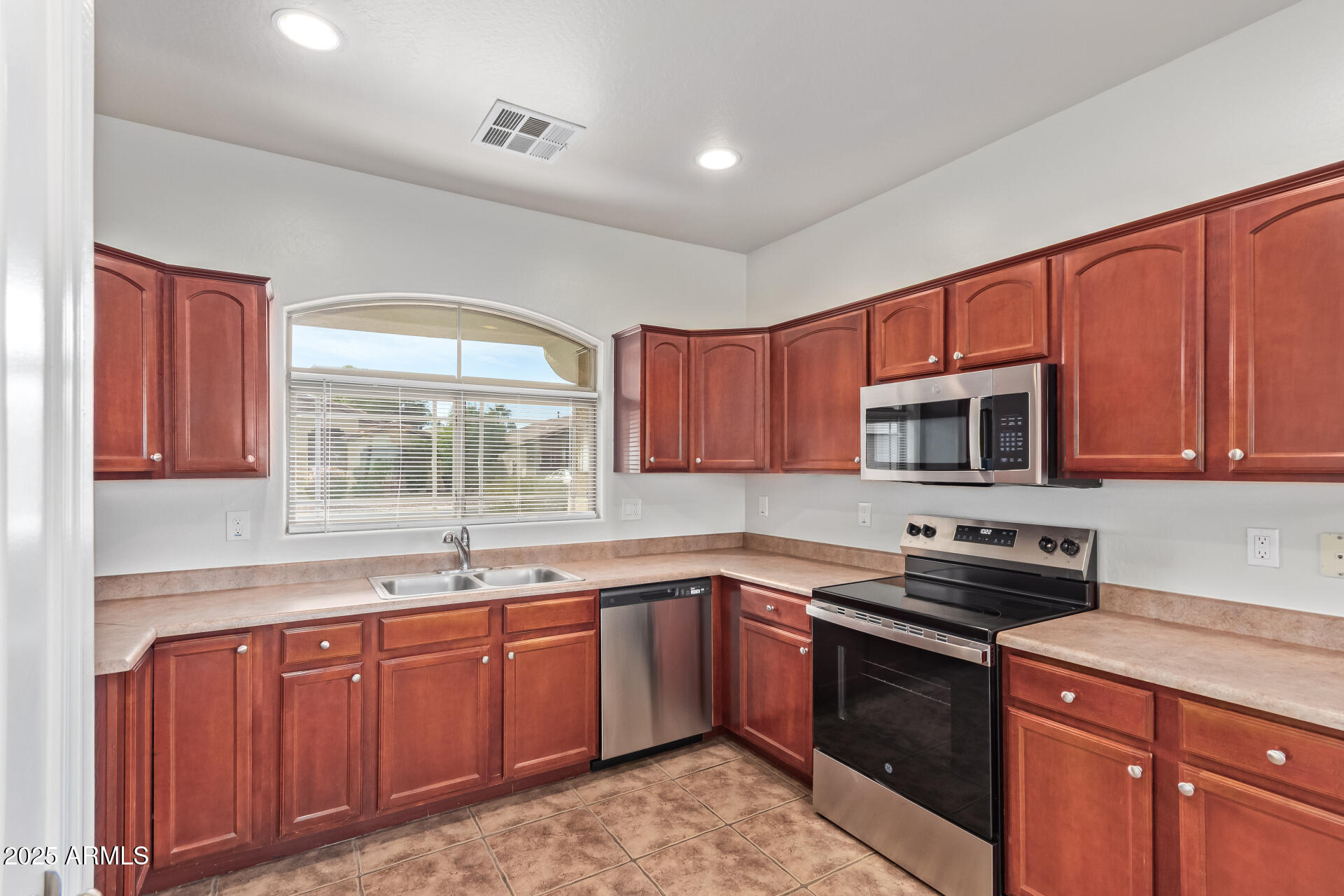 21382 East Via Del Rancho Queen Creek, AZ 85142 - Photo 4 of 29 a kitchen with a sink stove top oven and cabinets
