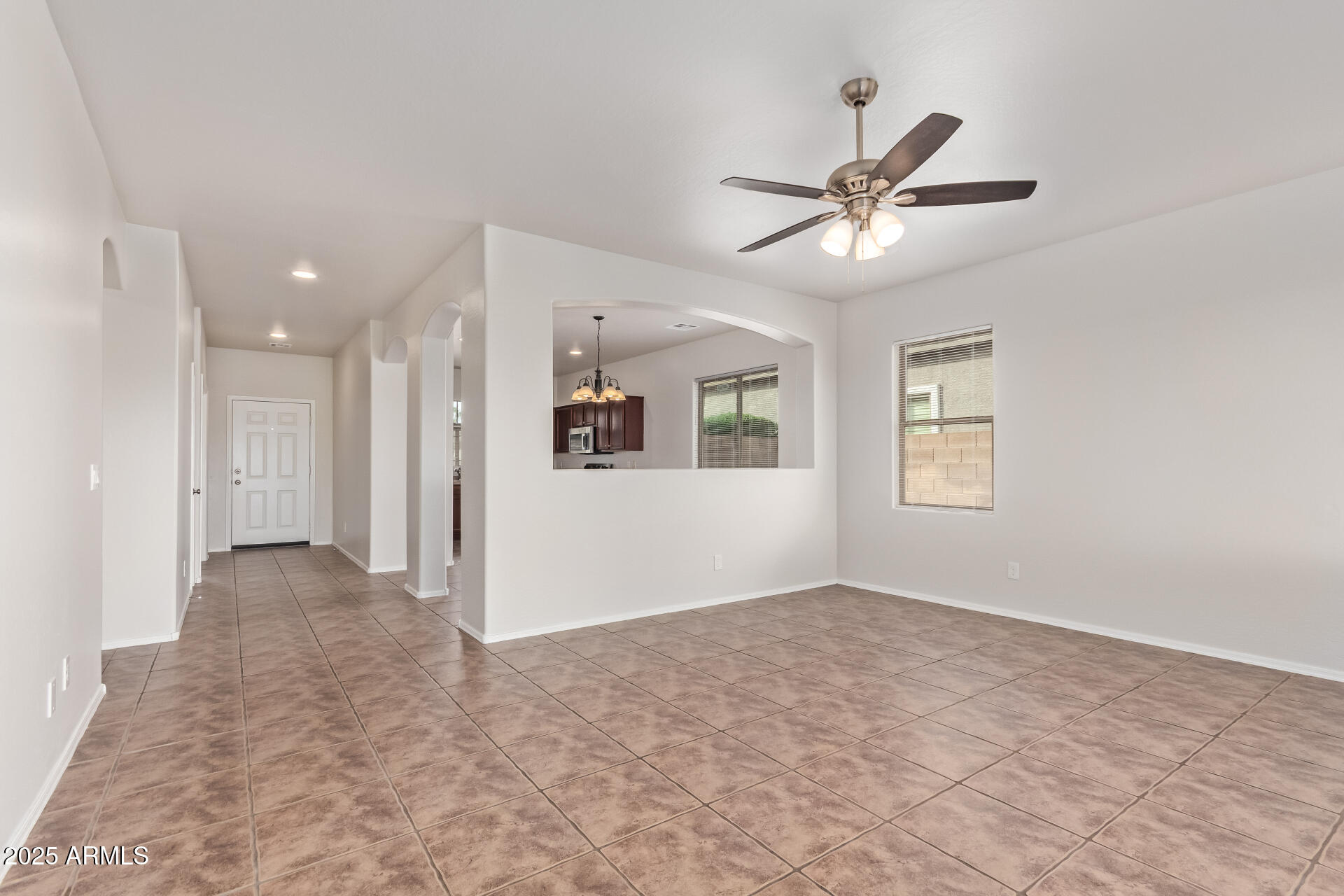 21382 East Via Del Rancho Queen Creek, AZ 85142 - Photo 8 of 29 a view of a livingroom with a ceiling fan & window