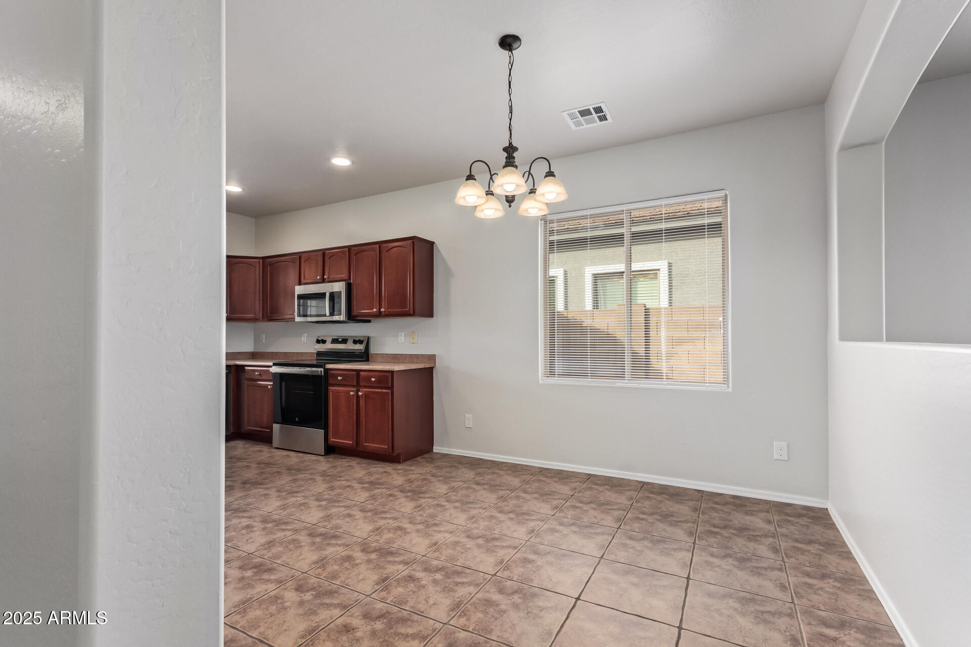 21382 East Via Del Rancho Queen Creek, AZ 85142 - Photo 9 of 29 a open kitchen with kitchen island granite countertop a stove sink and microwave